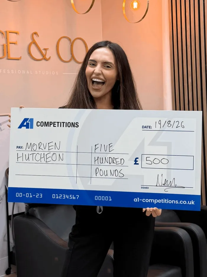 A1 Competitions winner holding a WINNER sign