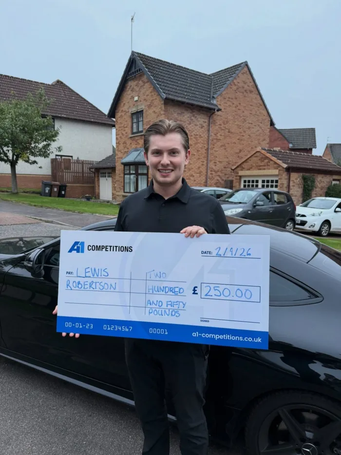 A1 Competitions winner holding a WINNER sign